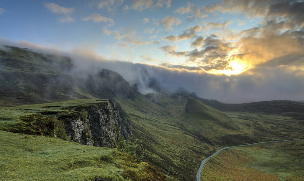 Green foggy forest road for sustainable mobility